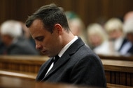 Oscar Pistorius puts his head down in court