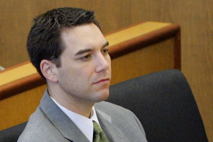 Scott Peterson sits in court in a grey suit