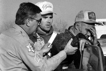 Merced County Sheriff Sgt. Gary Carlson, left, and Cary Stayner, center, comfort Delbert Stayner, right