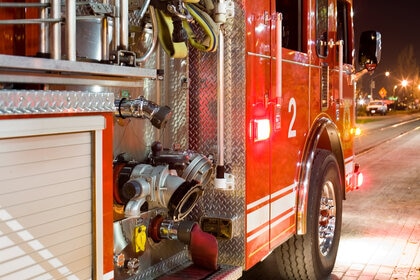 An image of a Fire Truck driving on a street