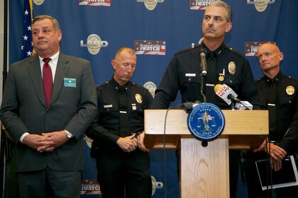 Kirk Albanese, at podium, takes questions from the media about a serial killer now in custody