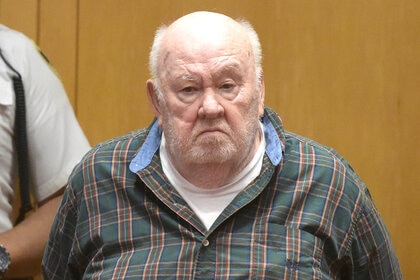 Marvin C. McClendon Jr. stands in the prisoner's dock