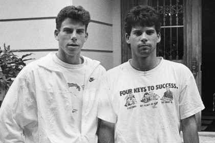 Erik Menendez and Lyle Menendez stand in front of their house in 1989