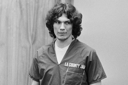 Richard Ramirez wears a prison jumpsuit entering court