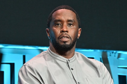 Sean "Diddy" Combs sits on stage during Invest Fest