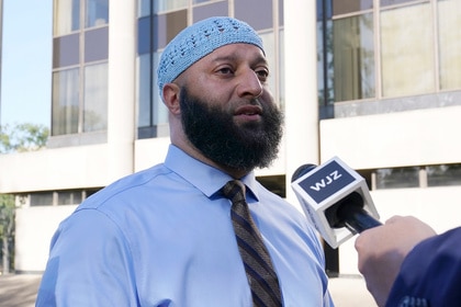 Adnan Syed speaks to reporters outside of the court house