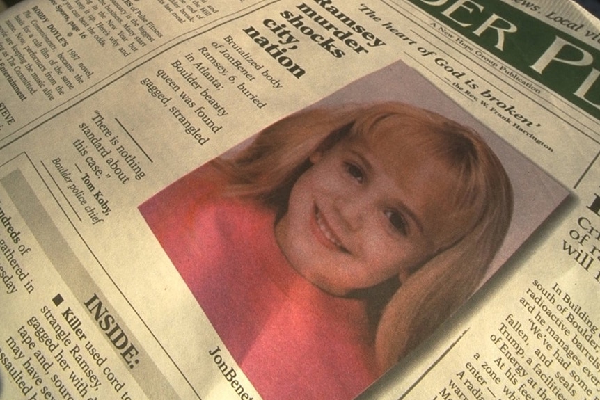 A newspaper features Jonbenet Ramsey