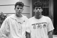 Erik Menendez and Lyle Menendez stand in front of their house in 1989