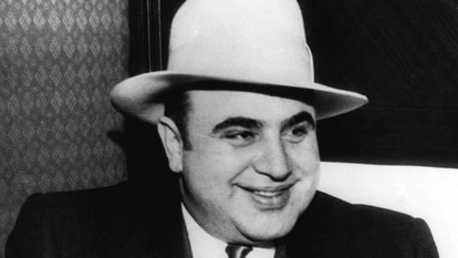 Al Capone wears a hat and smiles in 1930