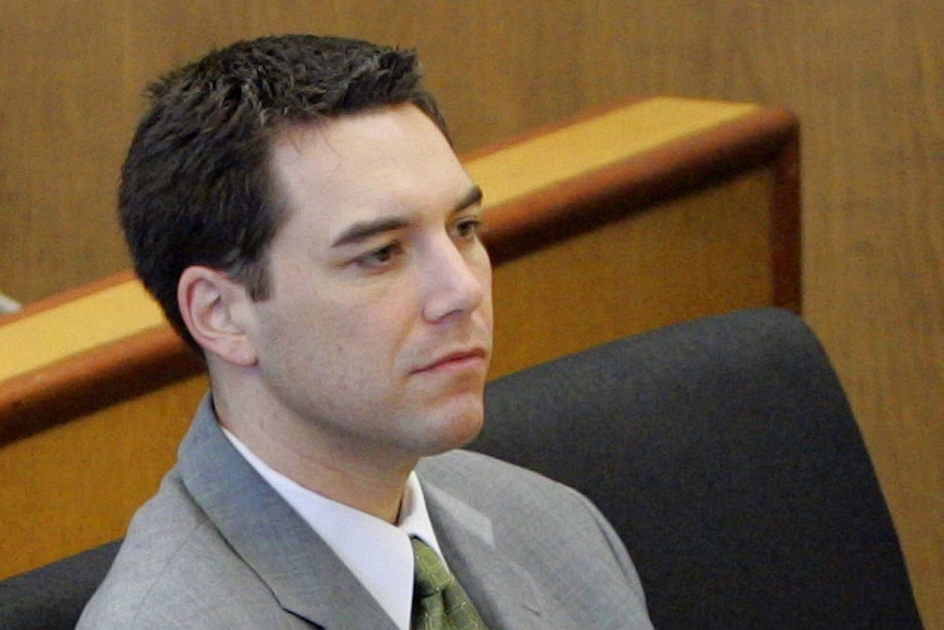 Scott Peterson sits in court in a grey suit