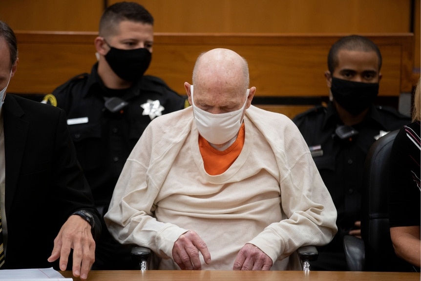 Joseph Deangelo sits in court with a mask on