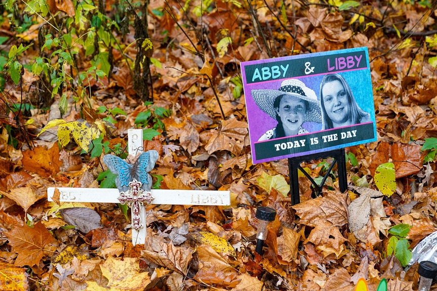 A memorial for Abigail Williams and Liberty German in a pile of leaves