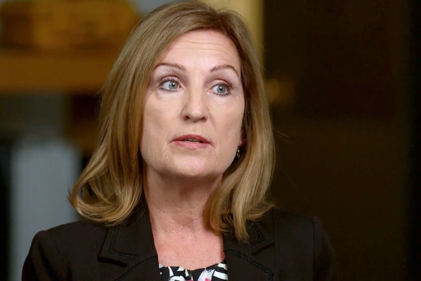 Detective Dianne Jennings during an interview wearing a black blazer and a black and white blouse