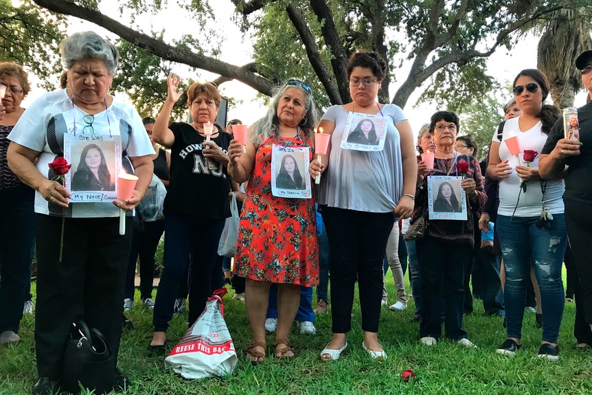 Family members hold a victims photo during a vigil of victims of Juan David Ortiz