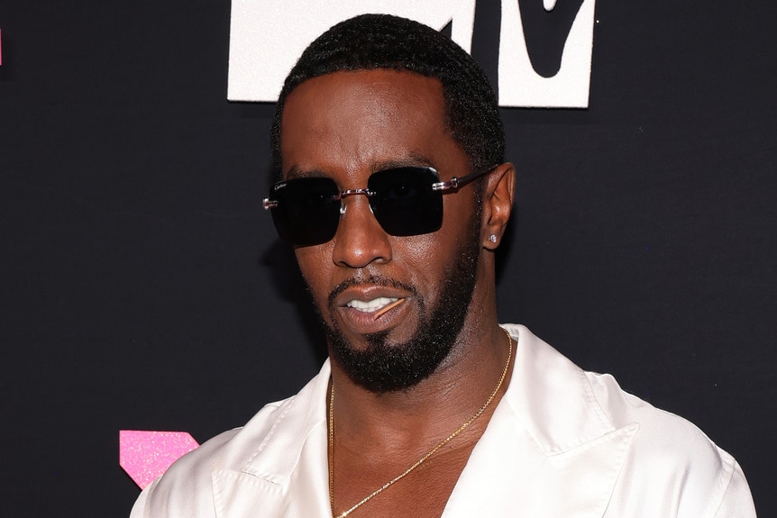 Sean "Diddy" Combs wears a white shirt on the red carpet